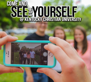 A person holding a smartphone captures a group photo of four people standing outdoors. The text reads "See Yourself @ Kentucky Christian University.