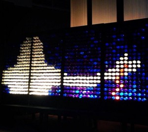 A colorful Lite-Brite display showing a rocket ship launching into space.
