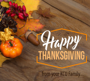 A "Happy Thanksgiving" message is displayed on a wooden surface, surrounded by autumnal items like an orange pumpkin, leaves, berries, and acorns.