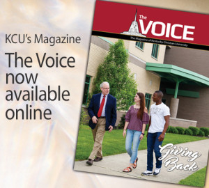 Cover of KCU’s magazine "The Voice" featuring three individuals walking and talking outside a campus building with text announcing that the magazine is now available online.
