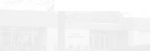 A faint image of a building labeled "Student Life Center" partially obscured by fog or overexposure, with a bare tree in the foreground.