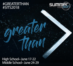 Blue handwritten text "greater than" next to a metallic, oversized greater-than sign on a dark, speckled background.